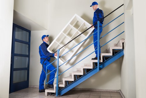 Removalists navigating a townhouse move in Camden