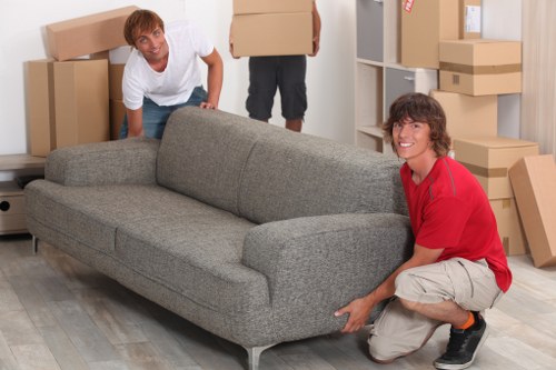 Local movers handling furniture in a Camden apartment building